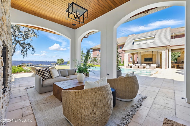 view of patio with an outdoor structure, an outdoor living space, and an outdoor pool