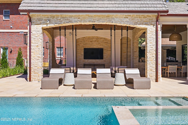 view of pool with a pool with connected hot tub, a patio, an outdoor hangout area, and ceiling fan