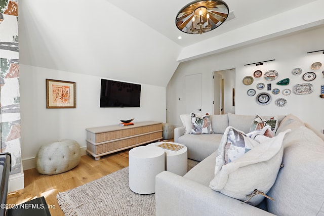 living room featuring lofted ceiling and wood finished floors