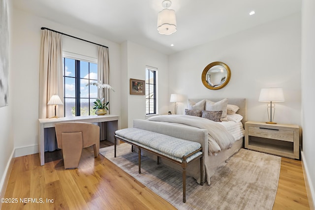 bedroom with light wood-type flooring, baseboards, and recessed lighting