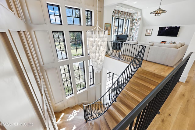 foyer featuring a high ceiling, a notable chandelier, and hardwood / wood-style floors