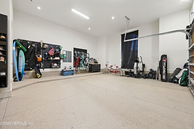 garage featuring electric panel and recessed lighting