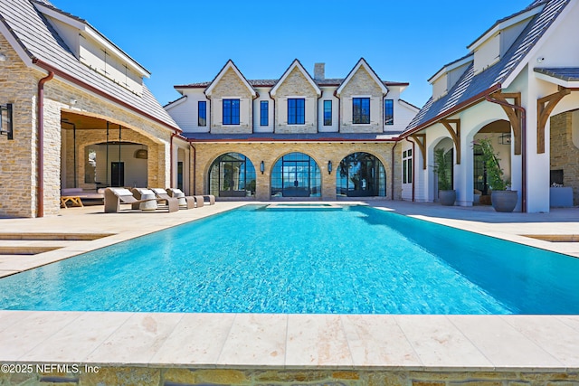 outdoor pool featuring a patio area and an outdoor living space