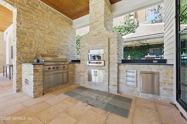 view of patio featuring exterior kitchen and grilling area