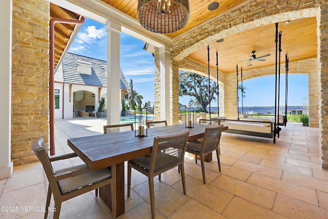 view of patio with ceiling fan, outdoor dining space, and an outdoor pool