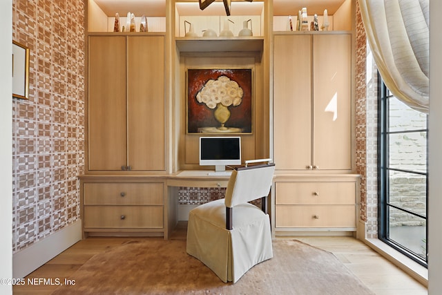 home office featuring built in study area, plenty of natural light, and light wood finished floors