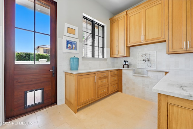 interior space with decorative backsplash and light tile patterned floors