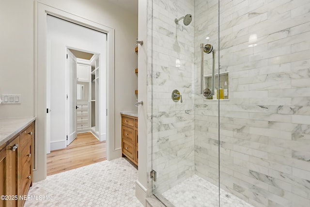 full bathroom with a stall shower and vanity