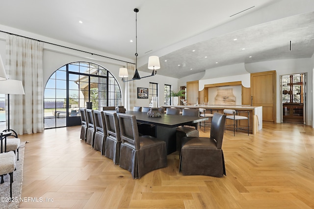 dining area with recessed lighting, a notable chandelier, and a high ceiling