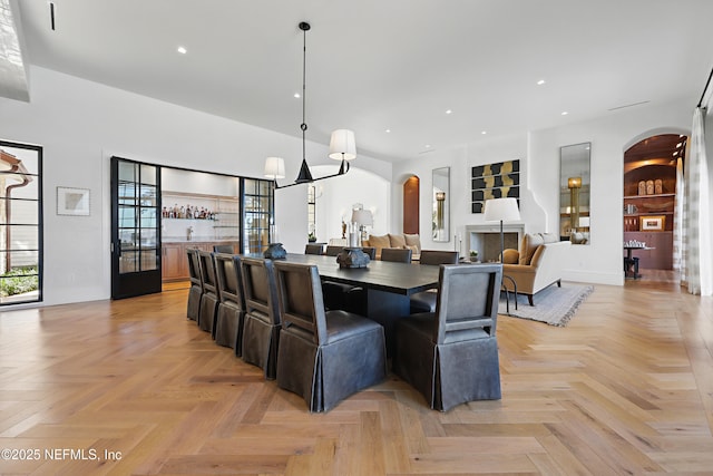 dining area featuring arched walkways and recessed lighting