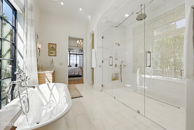 ensuite bathroom featuring ensuite bathroom, a soaking tub, and a shower stall