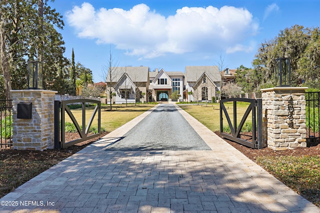 view of gate featuring a yard and fence