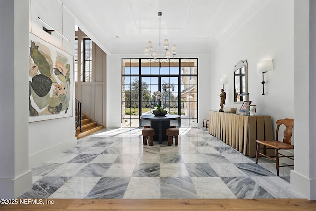 sitting room with an inviting chandelier, baseboards, stairs, and marble finish floor