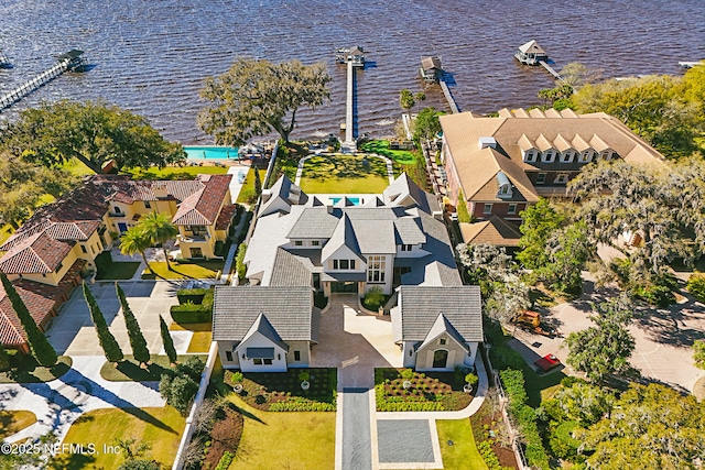 drone / aerial view with a water view and a residential view