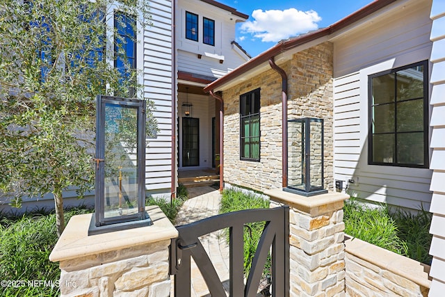 property entrance with stone siding