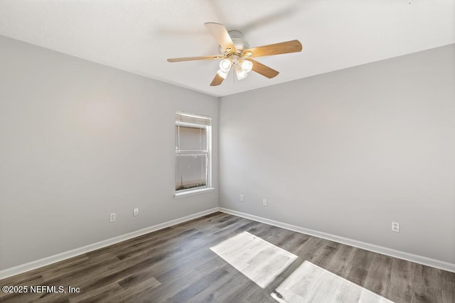 empty room featuring a ceiling fan, baseboards, and wood finished floors