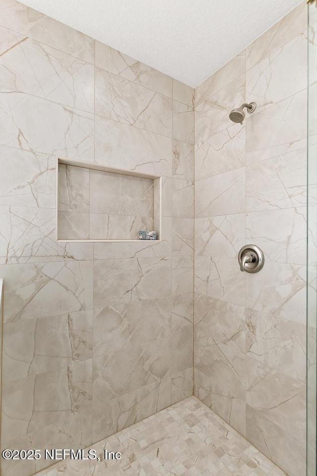 bathroom with a tile shower