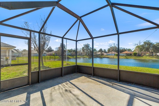 unfurnished sunroom with a water view