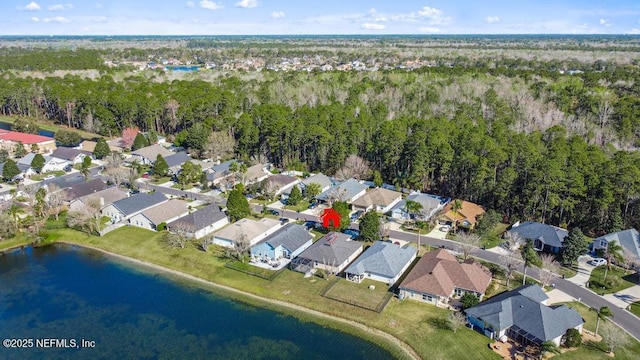 drone / aerial view with a water view and a residential view