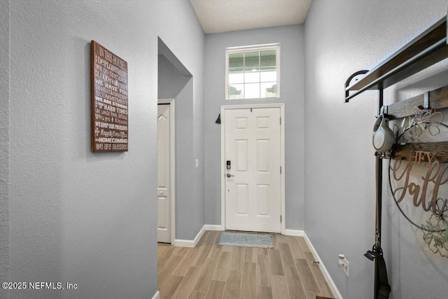 entryway with light wood-style floors and baseboards