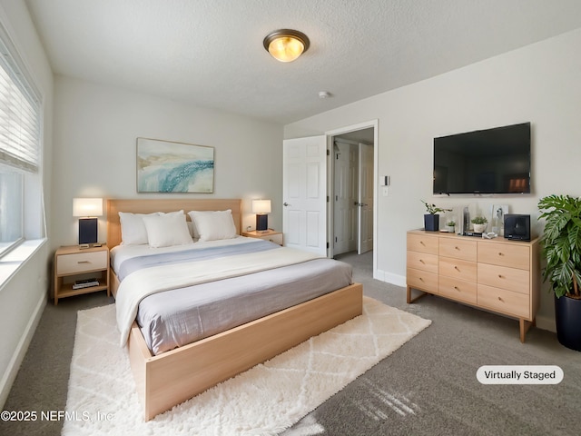 carpeted bedroom with a textured ceiling and baseboards