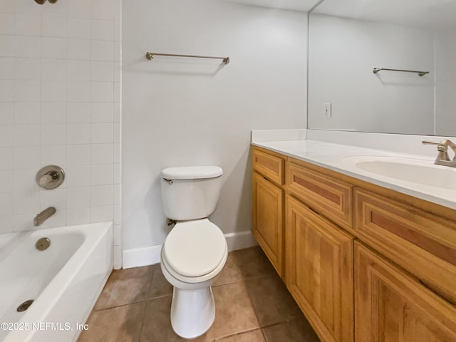 bathroom with toilet, tub / shower combination, vanity, tile patterned flooring, and baseboards