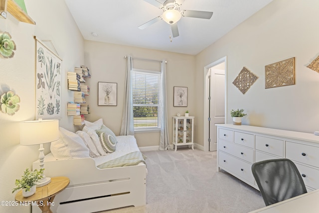 bedroom with a ceiling fan, baseboards, and light carpet