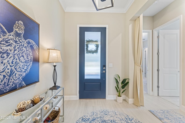 entrance foyer with baseboards and ornamental molding