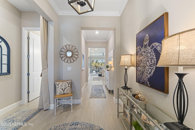 foyer with crown molding and baseboards