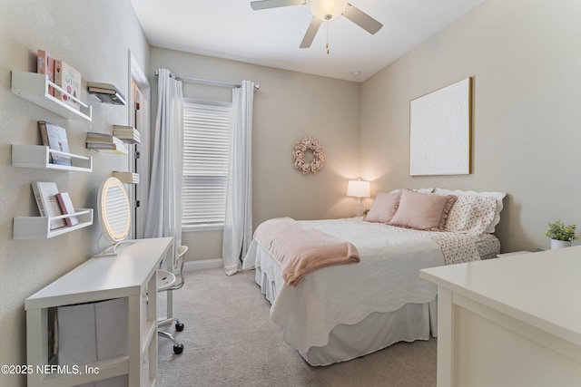 bedroom featuring a ceiling fan, light colored carpet, and baseboards