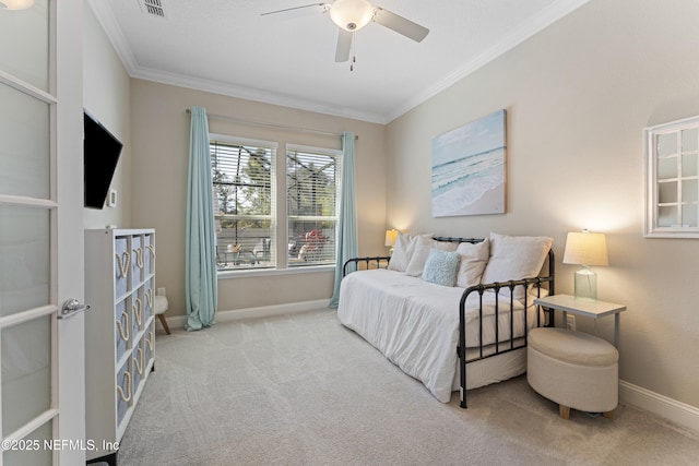 carpeted bedroom featuring visible vents, ceiling fan, baseboards, and ornamental molding