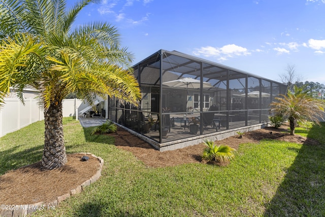 view of yard featuring a lanai, a fenced backyard, and a patio area