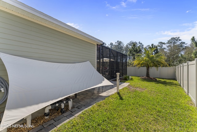 view of yard featuring a lanai and a fenced backyard