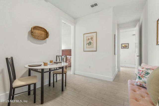 19 Essex Ln, Palm Coast, FL 32164 - dining space featuring baseboards, visible vents, and light wood-type flooring