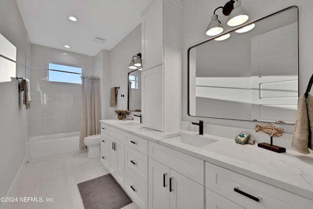 full bathroom featuring shower / bath combo, a sink, toilet, and double vanity