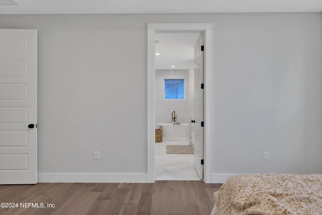 bedroom with recessed lighting, baseboards, and wood finished floors