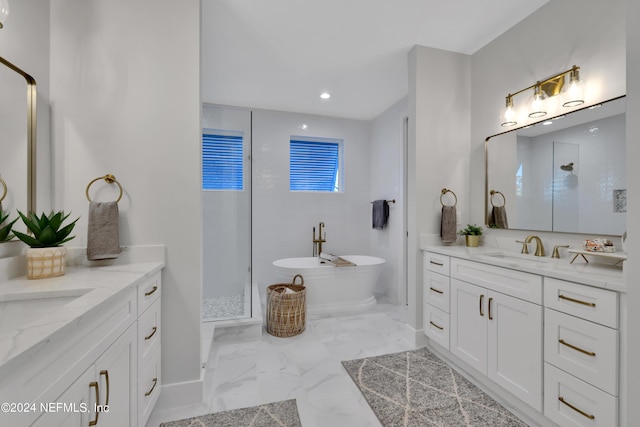 full bathroom with marble finish floor, two vanities, a sink, and a stall shower