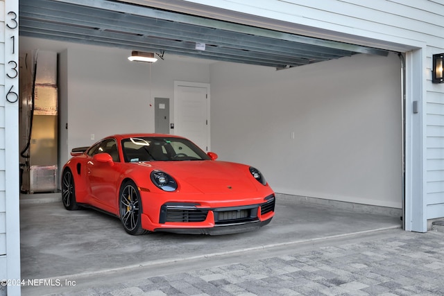 garage featuring electric panel and a garage door opener