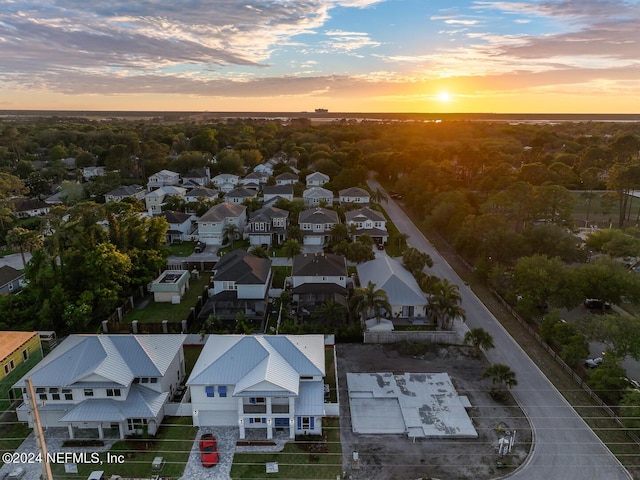 aerial view at dusk featuring a residential view