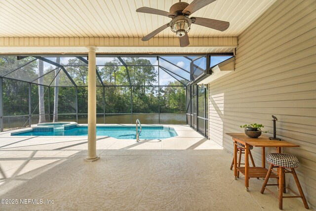 view of pool with a patio area, a pool with connected hot tub, glass enclosure, and a ceiling fan