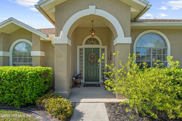 view of exterior entry with stucco siding