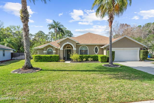 view of front of property featuring a garage, driveway, fence, and stucco siding