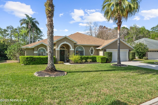 mediterranean / spanish house featuring driveway, an attached garage, a front yard, and stucco siding