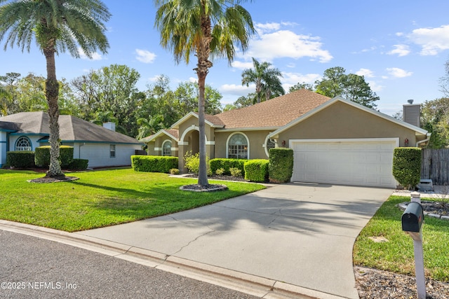 view of front of property featuring driveway, a garage, stucco siding, a chimney, and a front yard