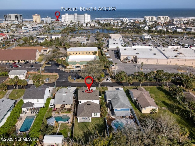 bird's eye view featuring a water view and a city view