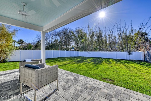 view of patio / terrace with a fenced backyard and a ceiling fan