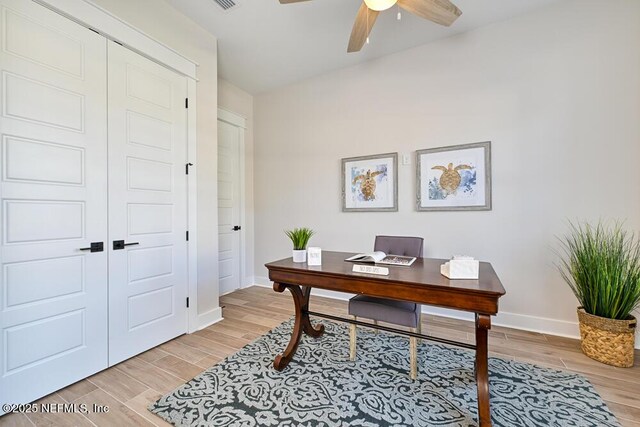 office area with baseboards, ceiling fan, wood tiled floor, and vaulted ceiling