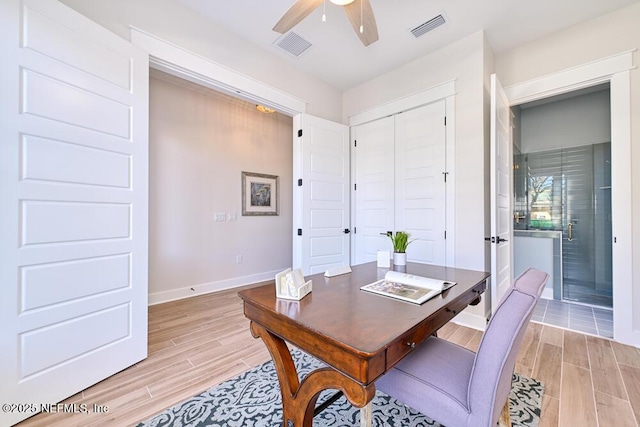 home office featuring wood finish floors, visible vents, baseboards, and ceiling fan