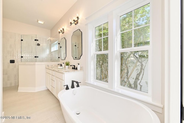 full bathroom with tiled shower, vanity, lofted ceiling, and a freestanding tub