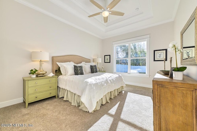 carpeted bedroom with a ceiling fan, a raised ceiling, baseboards, and ornamental molding